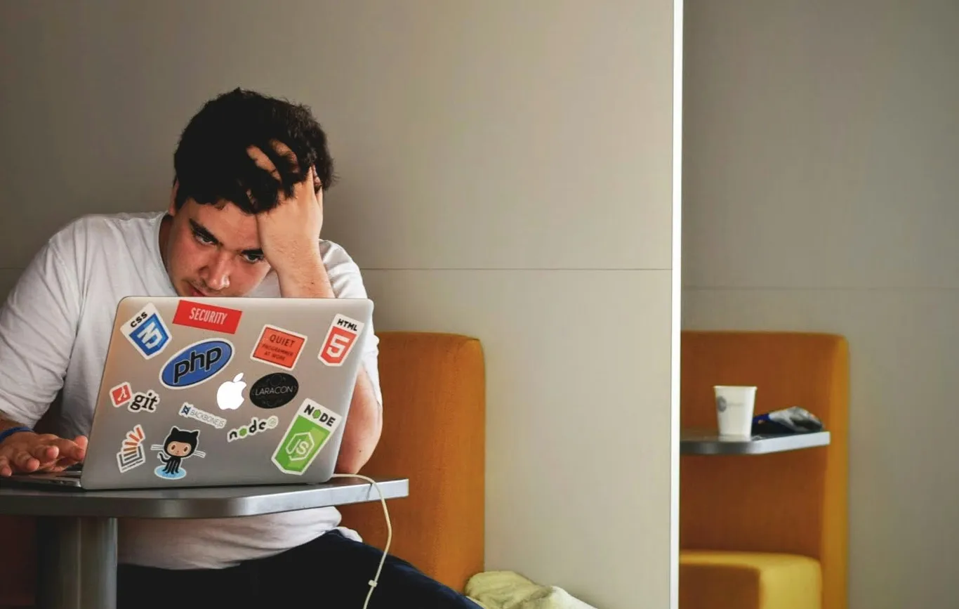 Man stressed using his laptop